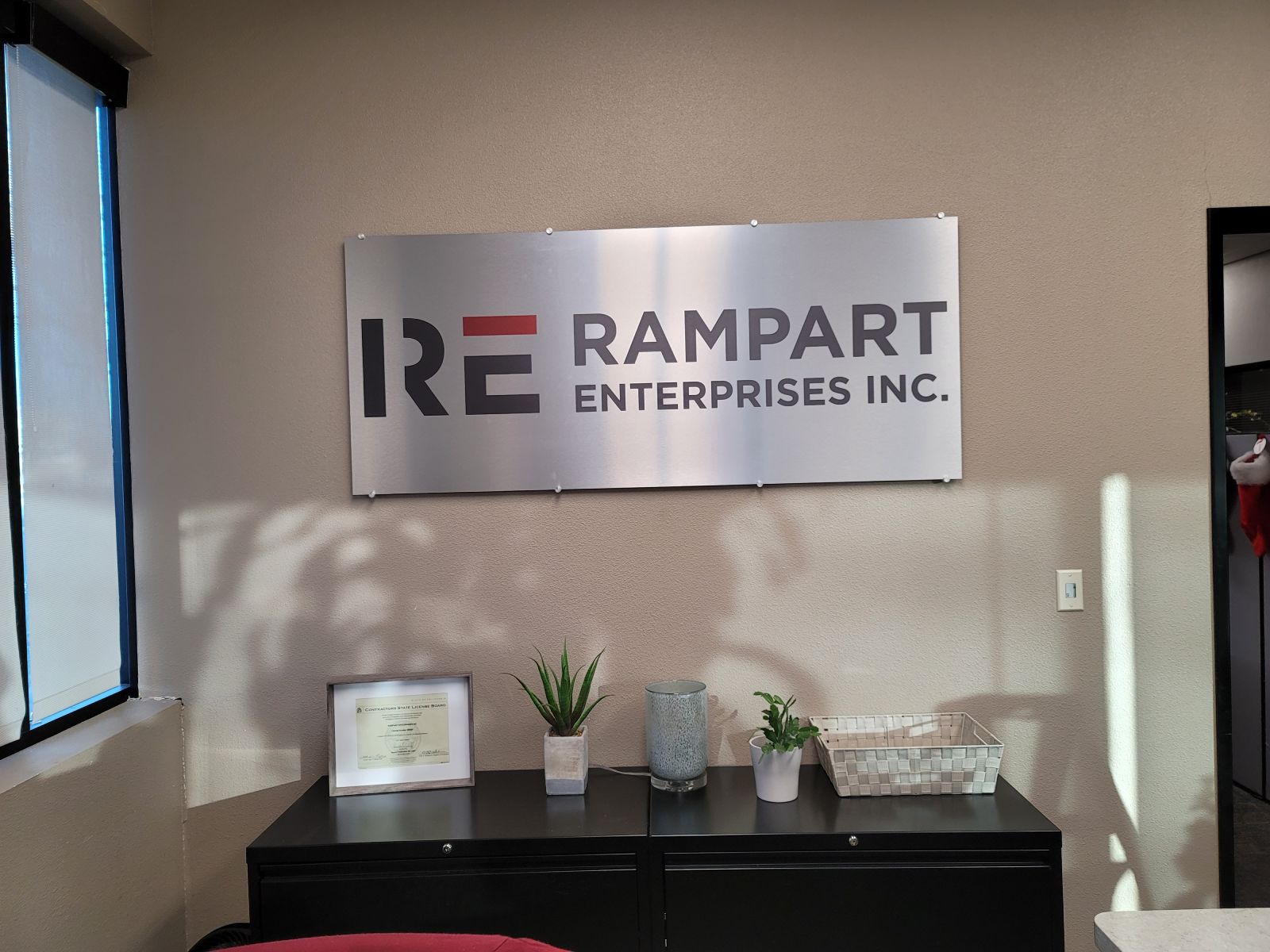 Brushed metal dimensional lobby sign for Rampart Enterprises