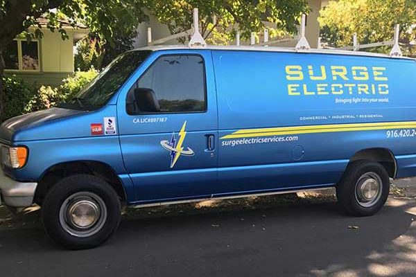 Surge Electric blue metallic full van wrap with logo and contact details