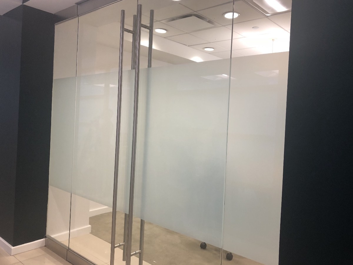 Commercial window film installed on floor-to-ceiling office glass partitions and doors