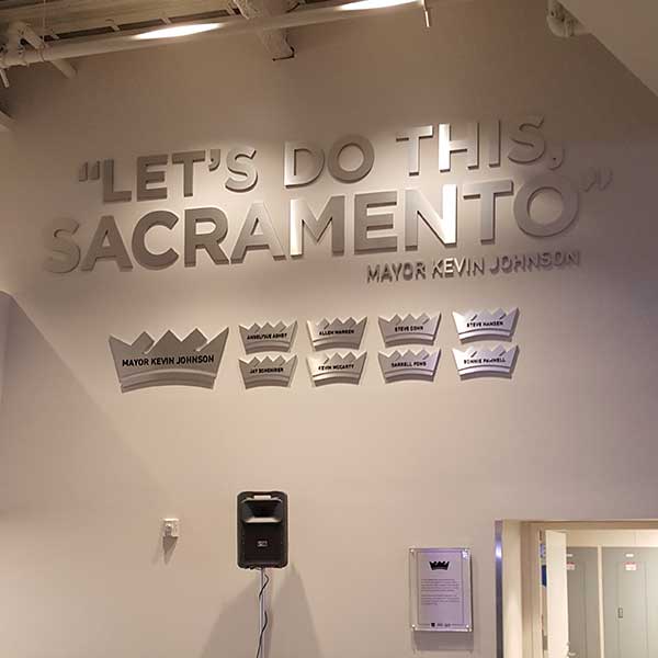 Brushed metal dimensional sign installation